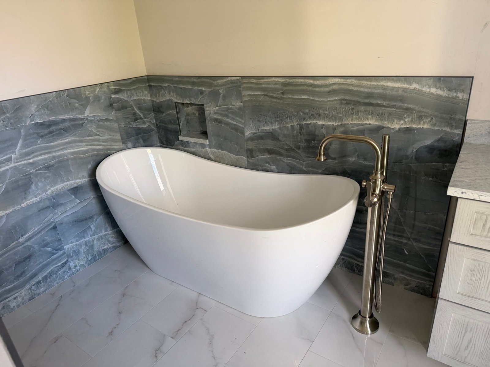 Marble tile bathroom remodel by Tile of America in West Yarmouth MA